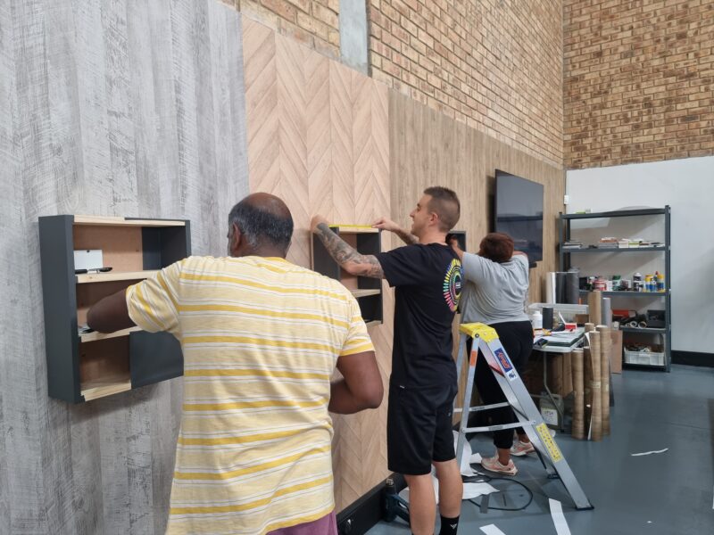 Trainees working on a panel at the Cover Styl' Training Centre