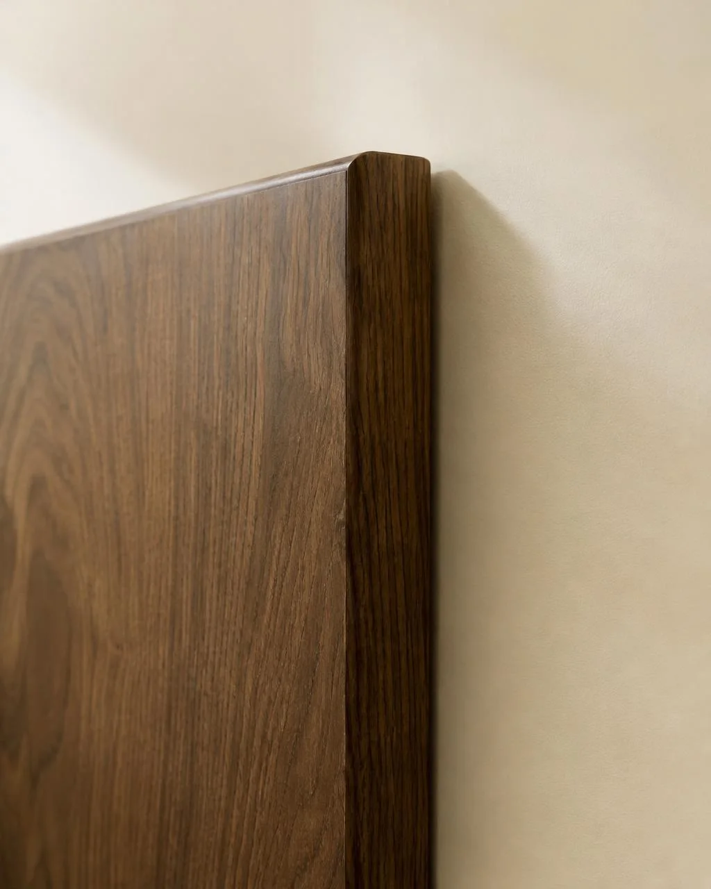 Cabinet door edge wrapped in a walnut wood film